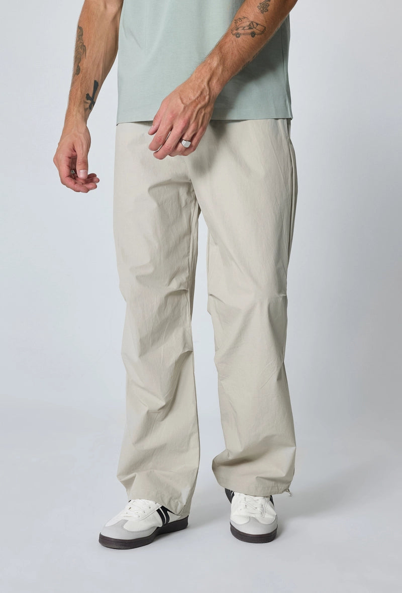 Parachute pants adjustable at the waist and ankles