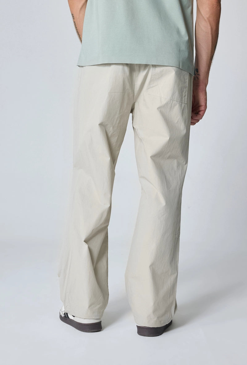 Parachute pants adjustable at the waist and ankles