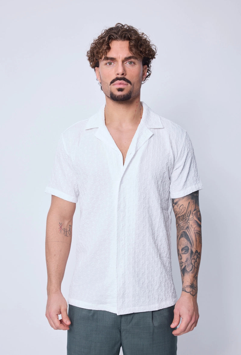 Chemise unie manches courtes à motifs géométriques